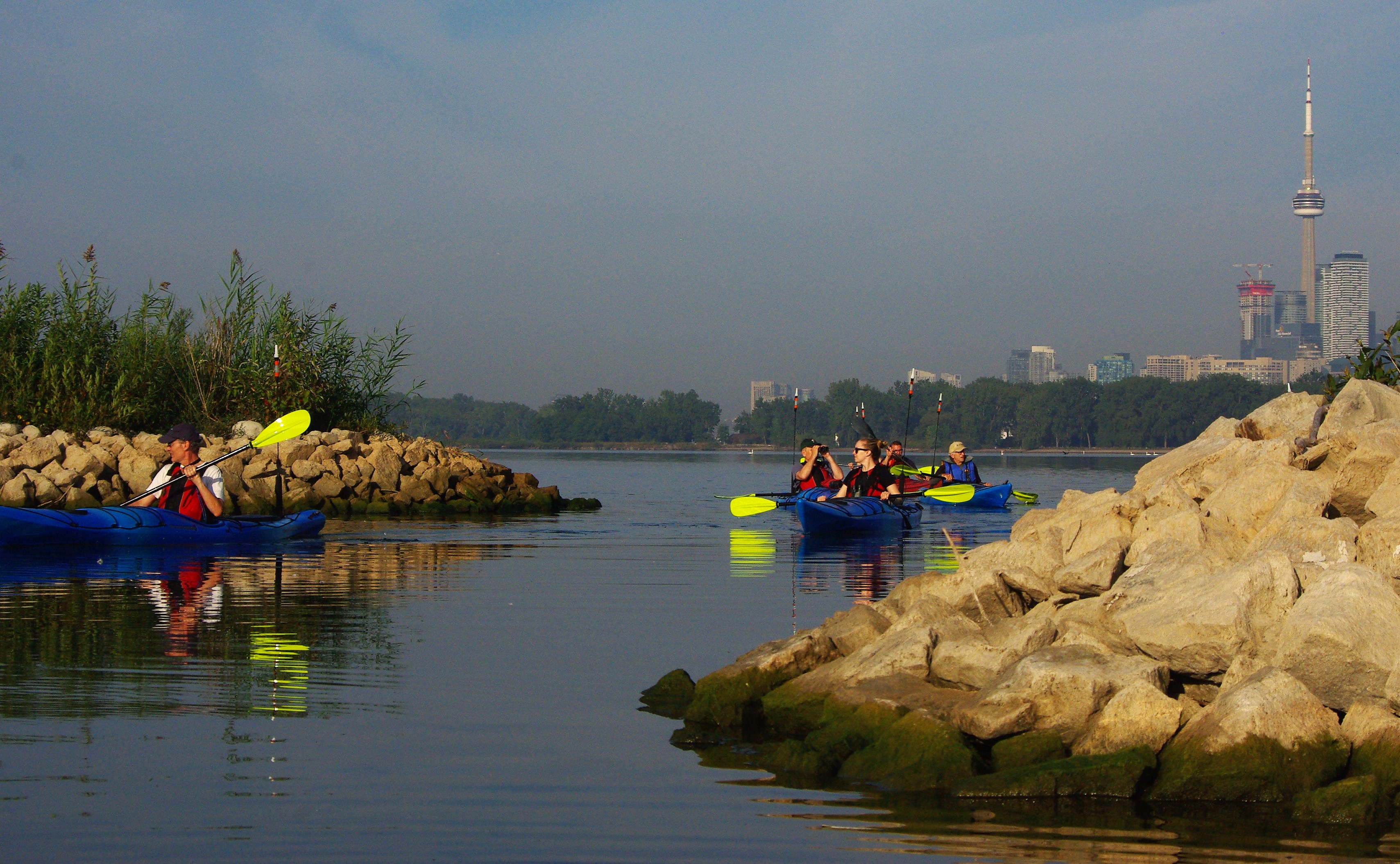 Kayakers at Tommy Thompson Park with the city of Toronto in the background