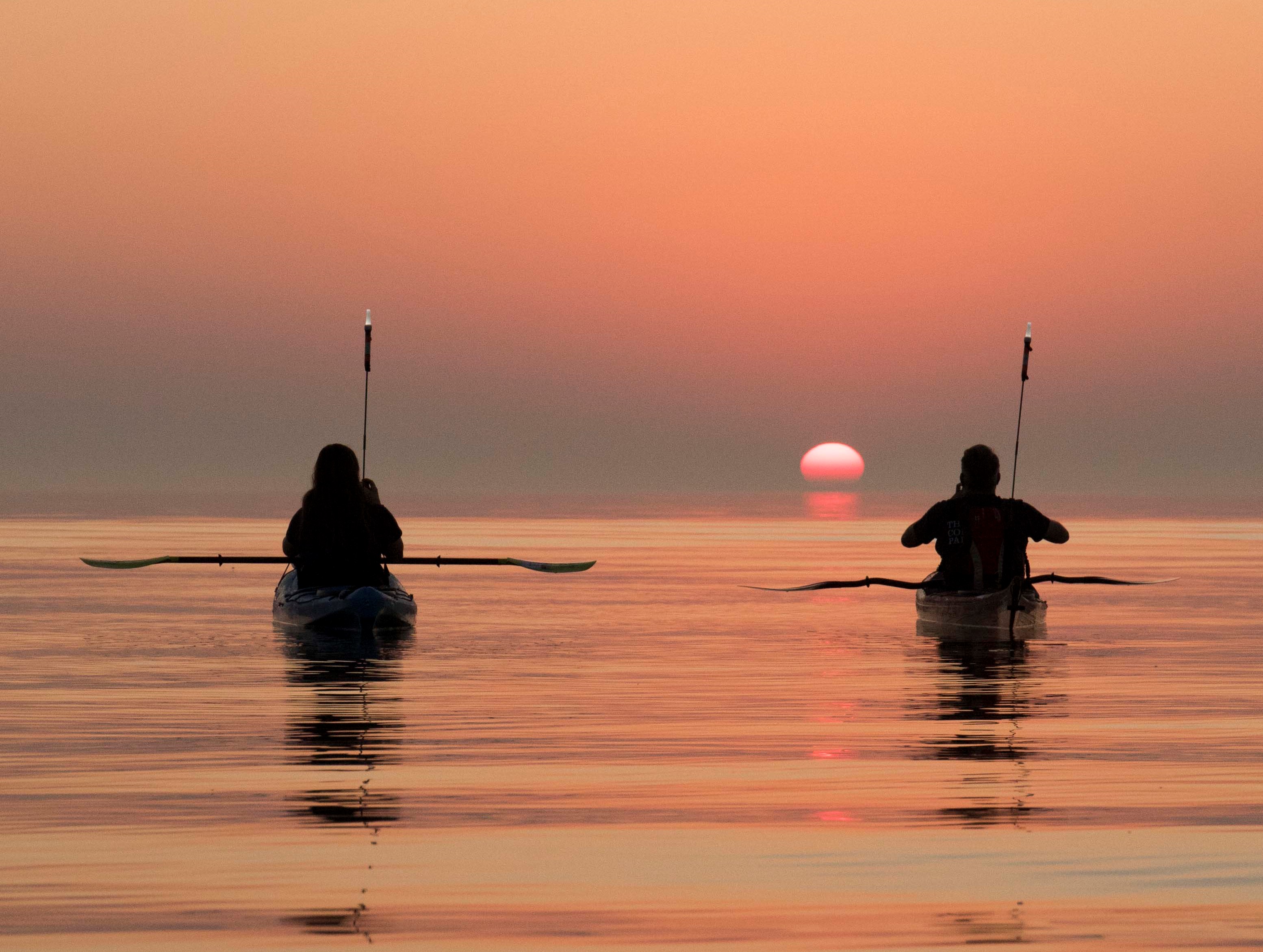 Watching sunrise in kayaks