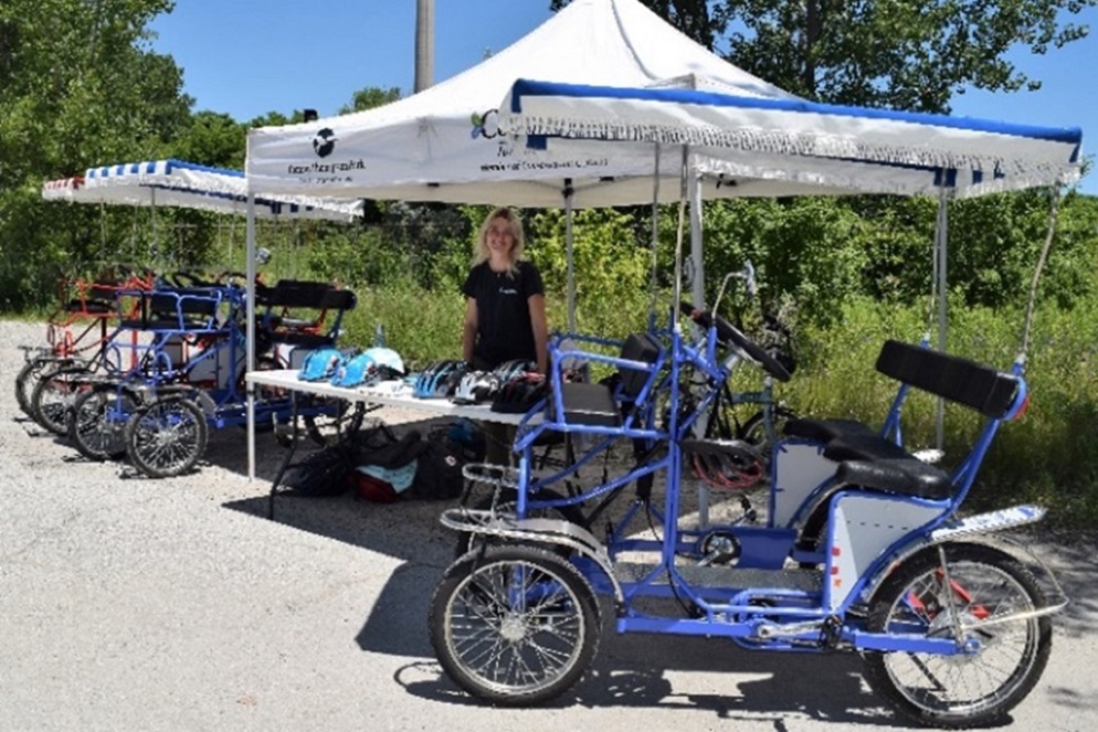 TRCA staff member at quadcycle rental booth at Tommy Thompson Park